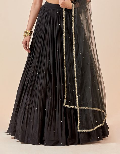 A lehenga set re-imagined for comfort and the celebration season vibes- this black lehenga brings you the charm of intricate hand embroidery that goes well with any occasion. As the first day of romance, this lehenga set is in full bloom with the voluminous lehenga skirt and beautifully done choli. This 3-piece set showcases a minimalistic charm attracting the purveyors of the "less is more" aesthetic.. Product Details. Color: Black. Work: Hand Embroidery. Style: Lehenga Set. Skirt Fabric: Crepe. Blouse Fabric: Chanderi Silk. Dupatta Fabric: Net