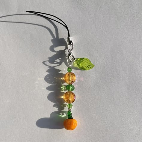 handmade pumpkin phone charm! handmade halloween... - Depop Fall Phone Charm Ideas, Halloween Beaded Jewelry Diy, Cute Handmade Halloween Jewelry, Handmade Halloween Necklace, Gelang Beads, Phone Charm Ideas, Halloween Phone Charm, Beaded Pumpkin Bracelet, Orange Keychain