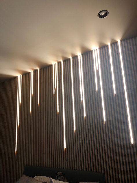 Wood slat wall with led track lighting Wood Slats Wall Decor, Wood Slat Wall And Ceiling Bedroom, Slatted Wall And Ceiling, Panels With Lights, Black Slat Wall Dining Room, Wood Panel With Led Lights, Slat Ceiling Lighting, Wooden Slats Ceiling, Horizontal Wall Slats Decor