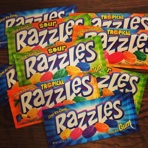 Razzles are a candy that once chewed, mix to transform into chewing gum. Originally introduced in 1966, with an advertising slogan and jingle of, "First it's a candy, then it's a gum. Little round Razzles are so much fun." The original flavor was raspberry. They were named after a fictional flavor, Razzleberry, that was planned but never panned out. This has also happened with the flavor "Zuzzleberry Zash". As well as "Tropical Tash". Razzles Candy, Advertising Slogans, 2000s Nostalgia, Vintage Candy, Chewing Gum, Candy Shop, Bubble Gum, Pop Tarts, Food Art