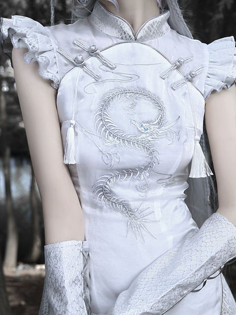 This stunning dress beautifully combines traditional Chinese cheongsam style with gothic aesthetics. The elegant silver dragon embroidery adds a touch of mystique, while the flutter sleeves bring a playful and feminine flair. Perfect for those who appreciate a unique blend of cultural and alternative fashion.   	 		 			Size 			S 			M 			L 		 		 			Bust 			85 			89 			93 		 		 			Full Length 			101 			102 			103 		 		 			Waist 			67 			71 			75 		 		 			Hips 			92 			96 			100 		 		 			Sleeve Len Shanghai Outfit, Dragon Embroidery, Chinese Qipao, Chinese Style Dress, Qipao Dress, Female Clothing, White Dragon, Cheongsam Dress, Inspo Board