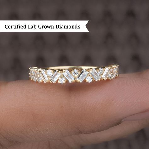 Vintage Style Baguette and Round Lab Diamond Wedding Band, 14K Baguette Diamond Ring, Half Eternity Anniversary Band, Dainty Stackable Ring ● 𝐃𝐢𝐚𝐦𝐨𝐧𝐝 𝐃𝐞𝐭𝐚𝐢𝐥𝐬: ➢ Shape: Baguette Cut and Round Cut ➢ Diamond Type: Lab Grown Diamond ➢ Color: EF ➢ Clarity: VS ➢ Carat:  0.7 TCW apx 𝐑𝐢𝐧𝐠 𝐃𝐞𝐭𝐚𝐢𝐥𝐬: ➢ Shank Width : 1.6 MM ➢ Shank Thickness : 1.5 MM 𝐀𝐥𝐥 𝐥𝐢𝐬𝐭𝐞𝐝 𝐫𝐢𝐧𝐠 𝐚𝐫𝐞 𝐦𝐚𝐝𝐞 𝐚𝐬 𝐚 𝐜𝐮𝐬𝐭𝐨𝐦 𝐨𝐫𝐝𝐞𝐫, 𝐚𝐧𝐝 𝐡𝐞𝐧𝐜𝐞, 𝐭𝐡𝐞 𝐦𝐞𝐚𝐬𝐮𝐫𝐞𝐦𝐞𝐧𝐭𝐬 𝐨𝐫 𝐜𝐚𝐫𝐚𝐭 𝐰𝐞𝐢𝐠𝐡𝐭 𝐜𝐚𝐧 𝐝𝐢𝐟𝐟𝐞𝐫 𝐬𝐥𝐢𝐠𝐡𝐭𝐥𝐲 𝐝𝐞𝐩𝐞𝐧𝐝𝐢𝐧𝐠 𝐨𝐧 𝐭𝐡𝐞 𝐚𝐯𝐚𝐢𝐥𝐚𝐛𝐢𝐥𝐢𝐭𝐲 𝐨𝐟 𝐝𝐢𝐚𝐦𝐨𝐧𝐝𝐬. 𝐅𝐨𝐫 𝐦𝐨𝐫𝐞 𝐝𝐞𝐭𝐚𝐢𝐥𝐬, 𝐟𝐞𝐞𝐥 𝐟𝐫𝐞𝐞 𝐭𝐨 𝐜𝐨𝐧𝐭𝐚𝐜𝐭 𝐮𝐬. ● 𝐂𝐞𝐫𝐭𝐢𝐟𝐢𝐜𝐚𝐭𝐢𝐨𝐧 We do provide Jewelry Certificate on request. It is cha Baguette Diamond Ring, Stackable Diamond Rings, Jewelry Certificate, Baguette Diamond Rings, Stackable Ring, Diamond Wedding Band, Baguette Cut, Anniversary Bands, Baguette Diamond