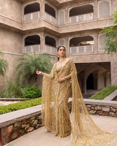 Liquid gold vibes 🌟 ...... MARISTELA - Metallic gold hand embroidered saree with a full sleeve blouse along tassel droplets at waist and gorgeous sequins edging. Cosmos: A Cocktail Affair Discover the collection: Online at Roujeofficial.com via link in bio Calcutta | Hyderabad Jewelry:@gkchudiwalas [ Roujeofficial, rouje, Cosmos, feathered cape, tassels, crystals, sequins, hand embroidery, cocktail saree, party outfits, after party outfit, bridesmaid outfit, Sangeet, wedding day, re... After Party Outfit, Embroidery Cocktail, Outfit Bridesmaid, Cocktail Saree, Bridal Reception Dress, Tulle Blouse, Gold Tulle, Reception Outfit, Full Sleeve Blouse