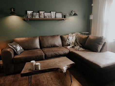 Green Living Room Brown Couch, Green Wall Brown Sofa, Dark Brown Coffee Table Living Rooms, Sage Green Living Room Brown Sofa, Sage Green And Dark Brown Living Room, Green Wall Brown Couch, Dark Green Rustic Living Room, Green And Dark Wood Living Room, Green Living Room Brown Sofa