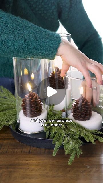 Christina Dennis on Instagram: "✨Cozy Centerpiece Idea✨ The IKEA cylinder vases are the perfect starting point for a gorgeous & sparkling centerpiece. Simply fill them with Epsom salt, add an Amazon faux pinecone candle to each one, and style on a tray with faux greenery and twinkle lights. The candles and greenery are linked in the Christmas list in my Amazon shops; link in my bi0! 🩷 Would you make this?

#thediymommy #ikeahack #centerpiece #christmasdecor #amazonfinds" Pinecones In Vase, Cylinder Vase Decor, Cylinder Vase Ideas, Pinecone Candle, Pinecone Centerpiece, Cylinder Lights, Pine Cone Candles, Low Centerpieces, Simply Filling