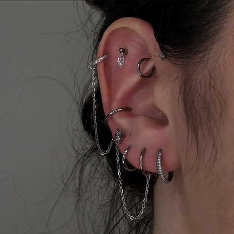 Goth Ear Curation, Pretty Industrial Piercing, Ears With Lots Of Piercings, Piercing Inspo Silver, Ear Piercing Ideas With Gauges, Silver Ear Curation, Edgy Ear Piercings Aesthetic, Ear Piercings Grunge, Alt Ear Piercings