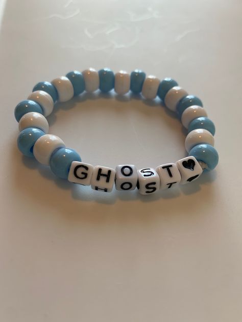 a blue and white kandi Bracelet with the words ghost on them. A great addition for a pastel goth aesthetic Pony Bead Ideas Bracelets, Blue Kandi Bracelets, Clay Bead Bracelet Ideas Emo, Kandi Bracelets Ideas Pony Beads, Spooky Bracelet, Halloween Kandi Ideas, Matching Kandi Bracelet Ideas, Kandi Ideas Bracelets, Word Bracelet Beads Ideas