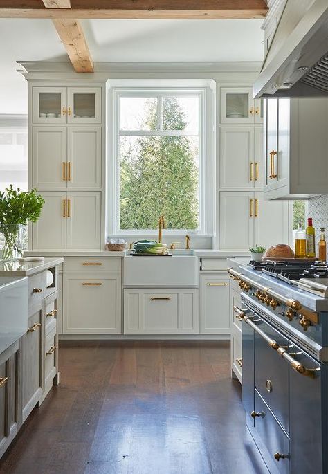 Kerry Hanson Design - White kitchen delivers a classic finish with white shaker cabinets and brass pulls. Ivory Shaker Kitchen, French Stove, French Farmhouse Kitchen, Kitchen Design White, White Shaker Cabinets, Shaker Kitchen Cabinets, French Country Kitchens, Dutch Colonial, White Kitchens