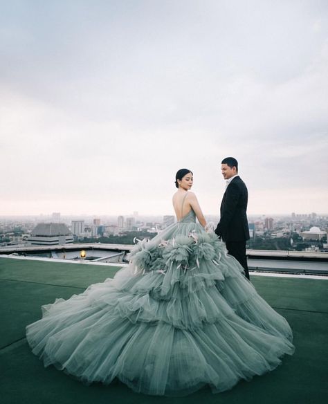 Prewedding shoot with bride wearing a flowing dress and groom in a black suit. Gown Prewedding Shoot, Prewedding Gown, Indoor Prewedding, Prewed Photoshoot, Powder Blue Gown, Prewedding Shoot, Wedding Frocks, Grey Gown, Ruffled Gown