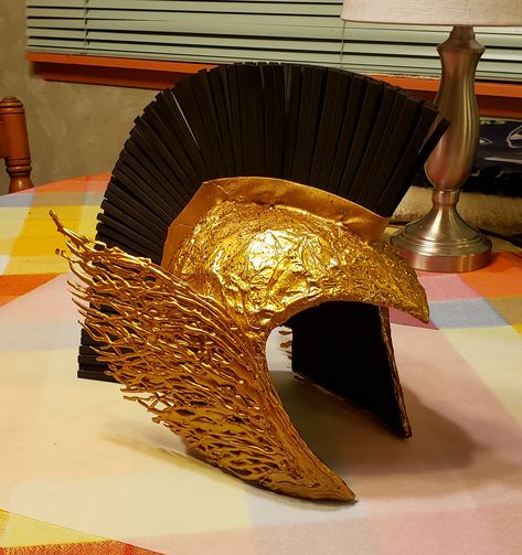 I made an Athena helmet for a library program. Diy Athena Helmet, Athena Goddess Costume, Athena Helmet, Odyssey Aesthetic, Athena Cosplay, Goddess Costume Diy, Spray Paint Crafts, Warrior Helmet, Leo Birthday