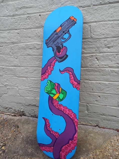 A custom skateboard with purple and pink tentacles holding a roll of money and a gun on a blue background Skateboard Design Diy Paint, Skateboard Deck Art Diy Paint, Spray Paint Skateboard, Custom Painted Skateboard Decks, Skateboard Custom Paint, Custom Painted Skateboard, Custom Skateboards, Skateboard Design, Using Acrylic Paint