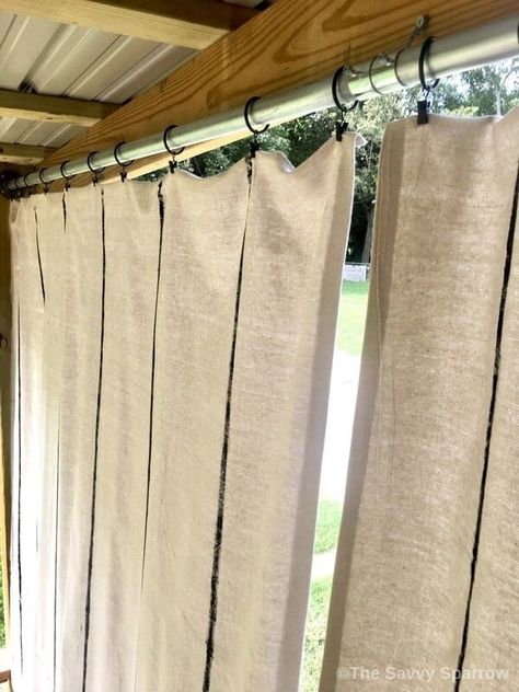 Drop cloth curtains are super easy to make with iron on adhesive and a little bit of paint! Make these DIY drop cloth curtains for outdoors in just a few simple steps, and get instant privacy on your porch or deck! Or hang these easy DIY curtains inside for a rustic farmhouse look. Outdoor Drop Cloth Curtains, Curtains On Back Porch, Curtains Porch Outdoor, Paint Cloth Curtains, Outside Curtains Patio Diy, Porch Curtains Outdoor Diy, Curtains From Drop Cloths, Drop Cloth Curtains Outdoor, Drop Cloth Curtains Diy