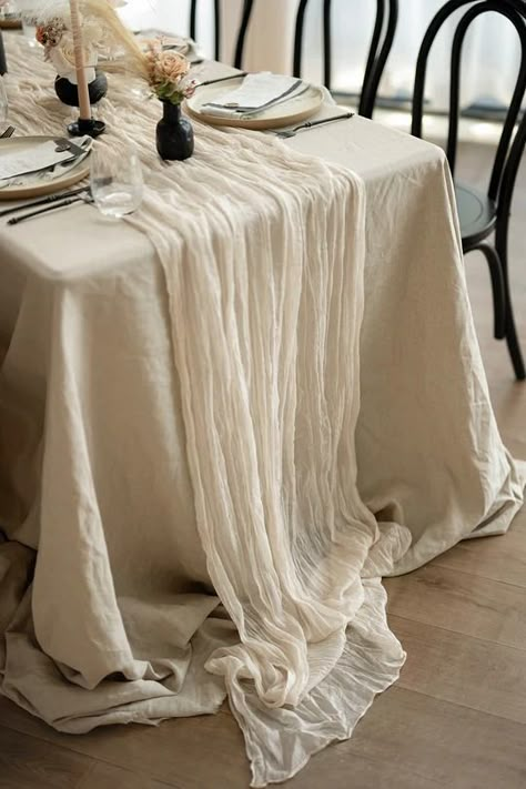 #CheeseclothTableRunnerIvory A rustic-elegant look with this wide hand-dyed color gauze table runner. It is unique and elegant for your wedding table, shower, party, Easter basket, or any occasion. PACKAGE DETAILS: Size: Approx. 35" wide and 10ft/14ft in length. Material: 7%viscose and 93%polyester, premium cheesecloth Table Cloth Setting Ideas, Wedding Table With Tablecloth, White Tablecloth With White Runner, Khaki Table Linens Wedding, Elegant Table Runners, Cheese Cloth Wedding Table Runners, Beige Event Decor, Textured Table Cloth Wedding, Bridal Shower Table Cloth Ideas