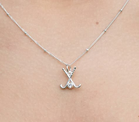 Wear this field hockey charm necklace as a symbol of your love for the game. Necklace features a charm with two, sterling silver plated field hockey sticks and man-made diamond "field hockey ball" on a sterling silver, 16" chain. Also available in 14k gold and 18k rose gold plated. Product details - Sterling silver plated 12mm field hockey charm with 1mm cubic zirconia- Sterling silver 16" chain with spring-ring closure- Brand logo at the clasp - Ready to gift on our jewelry stationery Shipping Hockey Necklace, Field Hockey Drills, Hockey Jewelry, Field Hockey Sticks, Hockey Drills, Sports Jewelry, Luxe Jewelry, Hockey Stick, Field Hockey