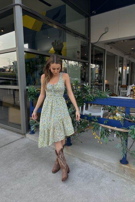 Coastal Cowgirl floral dress with brown cowboy boots Cowboy Boot With Dress, Boots And Dress Outfit Summer, Outfit Brown Cowboy Boots, Summer Dress Cowboy Boots, Floral Dress With Cowboy Boots, Cowboy Boot Outfits Dress, Cowboy Boots With Long Dress, Cowgirl Boot Skirt Outfit, Boho Cowboy Boots Outfit