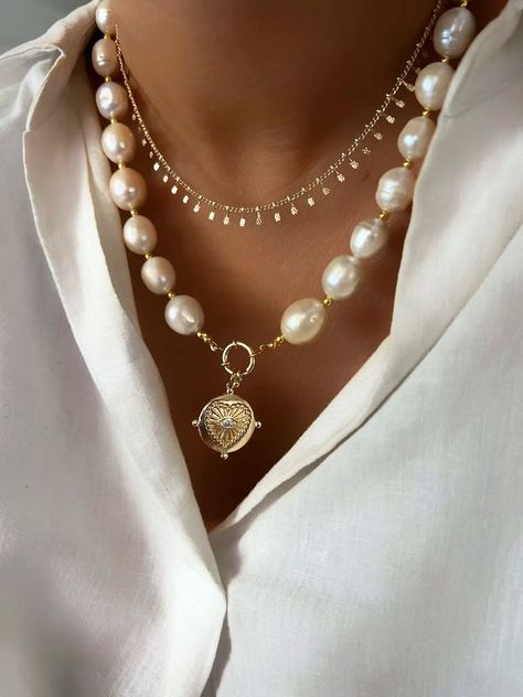 A pearl necklace featuring a gold plated heart charm with a small CZ stone. Jewellery Layering, Large Pearl Necklace, Accessories Styling, Pearl Necklace Gold, Pearl Beaded Necklace, Bling Ring, Gold Digger, Bead Necklaces, Baroque Pearl Necklace