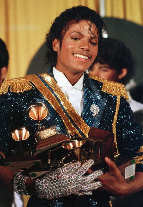 Michael Jackson was the first artist to win eight Grammys in a single night (a record since tied by Carlos Santana) when he swept with his "Thriller" album in 1984. Thriller Album, Michael Jackson Costume, Jheri Curl, Michael Jackson Images, Michael Jackson Wallpaper, Michael Jackson Art, Photos Of Michael Jackson, Michael Jackson Thriller, Michael Jackson Smile