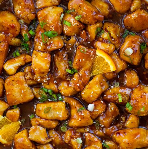 Orange Chicken is bite-sized pieces of chicken pan-fried to golden perfection, smothered in a sweet, tangy orange sauce with a subtle kick. Why not skip the takeout and try making homemade orange chicken instead? Serve it alongside some rice and garnish with green onions for a delicious restaurant-style meal right at home! You can also make the chicken in an air fryer. Chicken In An Air Fryer, Homemade Orange Chicken, Steamed White Rice, Easy Chinese Recipes, Orange Sauce, Freshly Squeezed Orange Juice, Asian Chicken, Sauce For Chicken, Orange Chicken