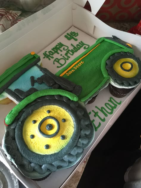 This Tractor Cupcake Cake was made by our local bakery. Our 4 yo absolutely loved his John Deere Cake with cupcakes. Click into the post for more great John Deere Party Ideas! Tractor Cupcake Pull Apart, Tractor Birthday Cupcakes, Tractor Shaped Cake, Farming Cake Ideas, Combine Birthday Cake, Tractor Themed Birthday Cake, Tractor Pull Apart Cupcakes, Green Tractor Cake, Tractor Birthday Cake For Boys