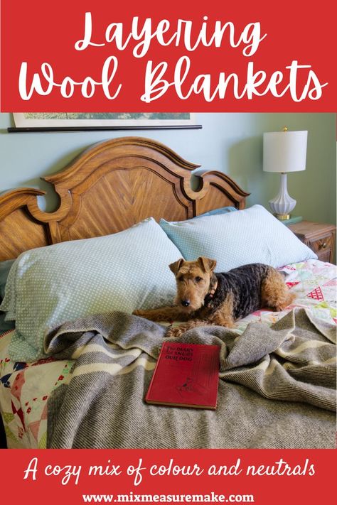 Layering Wool Blankets - an image of a bed with antique wood headboard, aqua pillow cases, colourful quilt, and a dark grey wool blanket laid on top, a welsh terrier laying on the bed with a vintage red book Layering Bedding, Mixing Colours, Welsh Terrier, Wool Blankets, Contents Design, Wool Blanket, Home Projects, Blankets, Color Mixing