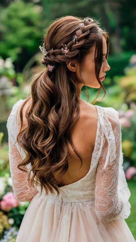 For those who adore braids, the braided crown half-updo is a stunning choice. This style involves weaving a braid from each side of the head, meeting in the middle to form a crown-like effect. The lower half can be left curly, wavy, or straight for added texture. It’s ideal for bridesmaids or anyone attending a formal event. Hair With Tiara Half Up Half Down, Princess Braid Half Up Half Down, Crown Braid Half Up Half Down Wedding, Half Up To The Side Wedding Hair, Hair Down With Two Braids On Side, Braided Updo Half Up Half Down, Wedding Hair With Plaits Half Up, Viking Half Up Half Down Hair, Braided Hair Crown Half Up