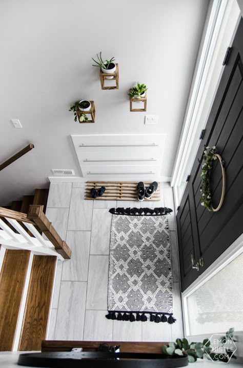 DIY Split Level Entry Makeover- I LOVE this entry. The oversize door, scandi influence and that shoe storage!  #EntryWay #HomeOrganization #HomeDecor #HomeDecorIdeas #HomeDecorating Split Level Entry, Entry Makeover, Split Entry Remodel, Split Level Entryway, Split Level Remodel, Split Entry, Interior Design Blogs, Split Foyer, Farmhouse Side Table