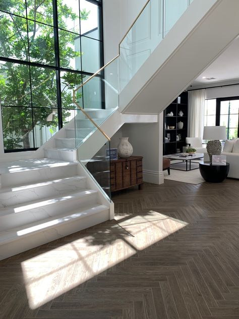 Exactly the stair design we like. Wall panneling on their stairs and the same windows. Glass Balustrade with Brass trim Glass Balustrade Stairs, Luxury Basement, Stairs Background, Big Glass Windows, Glass Stair, Wall Stairs, Living Room Redesign, Front Stairs, White Staircase