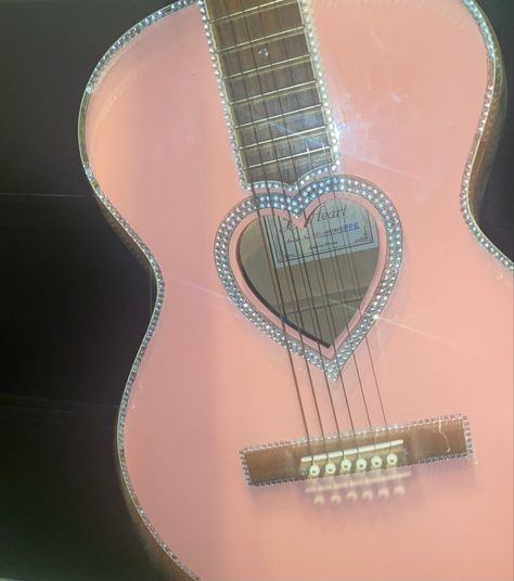 Blurry picture of a pink guitar covered in gems with a heart shaped tone hole Guitar Drawing Aesthetic, Heart Guitar, Aphrodite Cabin, Guitar Light, Pink Guitar, Olivia Jade, Guitar Drawing, Pink Music, Drawing Aesthetic