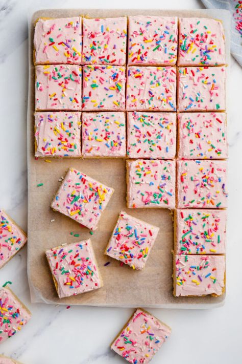 Thick, chewy Sugar Cookie Bars are topped with a sweet frosting and sprinkles! This is such an easy recipe that is perfect for literally any occasion! Get creative and decorate them in bright colours for Easter! #cookie #bars #dessert #sugarcookie Sugar Cookie Bars Southern Living, Southern Living Sugar Cookie Bars, Valentine Sugar Cookie Bars, Easy Party Sweet Treats, Summer Dessert Bar Recipes, Sugar Cookies Bars Recipe, Sugar Cookie Sheet Bars, Funfetti Sugar Cookie Bars, Cooking With Karli Sugar Cookie Bars