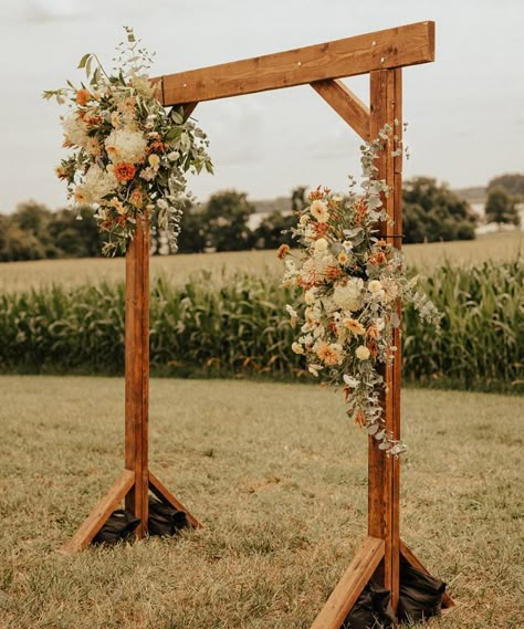 Wooden ceremony arch with florals attached Cedar Arch Wedding, Garden Wedding Arch Outdoor Ceremony, Wedding Wooden Arch Ideas, Wooden Arch Backdrop Wedding, Cedar Wedding Arch, Arbor Wedding Ideas, Wedding Arch Flower Arrangements, Corn Field Wedding Ceremony, Wooden Wedding Arch With Flowers