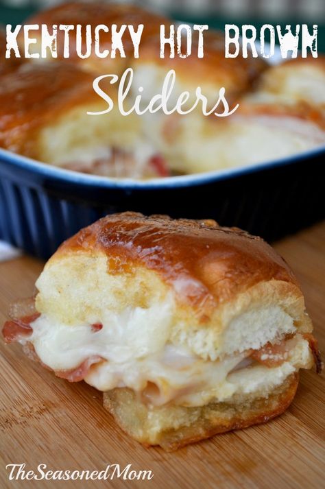 These sliders are stuffed with turkey, bacon, and Gruyere cheese, and are coated in a garlic, butter sauce for an irresistible party snack. Hot Brown Sliders, Kentucky Hot Brown Sliders, Kentucky Hot Brown, Slider Sandwiches, Hot Brown, Food Inc, Garlic Butter Sauce, Tailgate Food, Slider Recipes