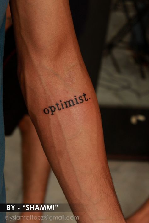 optimist , Tattoo by shammi sharma at Elysian tattoo studio . for details contact  - 9039469612 Optimistic Tattoo Ideas, Meaningful Word Tattoos For Men, Optimistic Tattoos, Optimism Tattoo, Optimist Tattoo, Elysian Tattoo, No Fear Tattoo, Minimalist Tatoos, Hood Tattoos