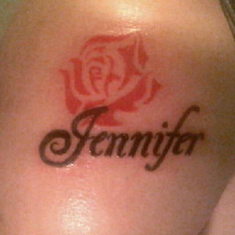 Black "Jennifer" name tattoo, with no outline red rose. I did this one over the weekend. It's on a man, so I did a tribal like rose, freehand. You like it?? Artist Allison Birdy Quick Jenny Tattoo Name, Jennifer Tattoo Name, Jennifer Name, Heaven Tattoos, Biker Tattoos, Mommy Tattoos, Tattoo Name, Tattoo Fails, Lettering Ideas