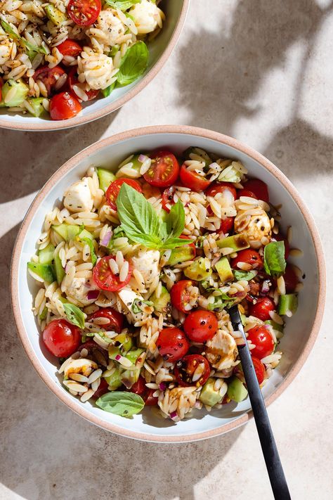 Try this refreshing Orzo Caprese Salad for a delightful twist on a classic dish! Cooked orzo pasta is combined with juicy cherry tomatoes, fresh basil leaves, and creamy mozzarella balls. The salad is dressed with a super simple balsamix dressing with an extra drizzle of balsamic glaze. It's perfect as a light lunch or a side dish for any occasion. Pasta Salad With Mozzarella, Mediterranean Salad Recipe, Garlic Roasted Broccoli, Sun Dried Tomato Sauce, Mozzarella Balls, How To Cook Orzo, Caprese Pasta Salad, Classic Salad, Caprese Pasta