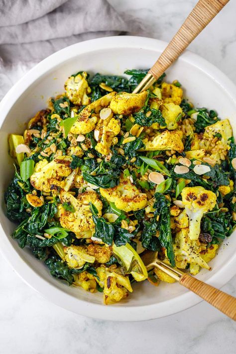 This Roasted Cauliflower Salad recipe is incredibly flavorful. Cauliflower is roasted until tender-crisp, then tossed with farro, lacinato kale, scallions, raisins, and toasty almonds in a savory-sweet turmeric dressing. Vegan. Turmeric Dressing, Cauliflower Salad Recipe, Lacinato Kale, Feasting At Home, Roasted Cauliflower Salad, Farro Salad, Cauliflower Salad, Wheat Berries, Veggie Side Dishes