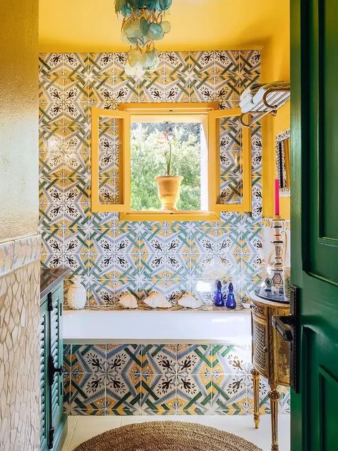 Put down the seashells and seafoam green paint! We're showing you how to create a coastal bathroom that doesn't feel at all cliché.  Think: Koi fish wallpaper, a two-toned shower curtain, and more design inspiration from our favorite coastal bathrooms.