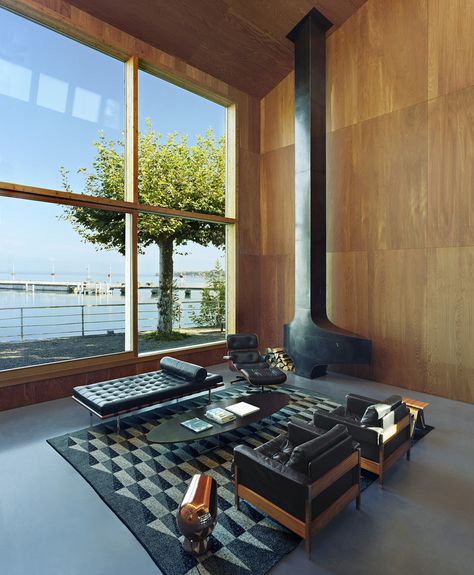 The 6,780-square-foot interior is completely lined in larch, a wood grown in the surrounding Alps and selected to give the feeling of an Alpine home. The metal fireplace was bought off-the-shelf from the French fireplace company Focus. ‘The model is from the ‘70s, made for a French ski resort,’ Mr. Dentand says. Barcelona Couch, Eames Coffee Table, Leather Daybed, Interior Minimalista, New York Apartment, Lake Geneva, Interior Design Magazine, Steel House, Ray Eames