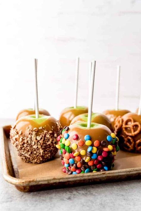 Gourmet Homemade Caramel Apples are easy and fun to make! The sweet, buttery caramel is perfect with crisp, tart Granny Smith apples, and you can decorate them with as many crunchy, chewy, nutty or crispy toppings as you want! #caramelapples #apples #caramel #Halloween #fall #dessert #candy #fromscratch #homemade #easy #recipe Caramel Apple Recipe, Covered Apples, Gourmet Caramel Apples, Candy Apple Recipe, Caramel Apples Homemade, Caramel Apples Recipe, Caramel Apples Easy, Chocolate Covered Apples, Gourmet Apples