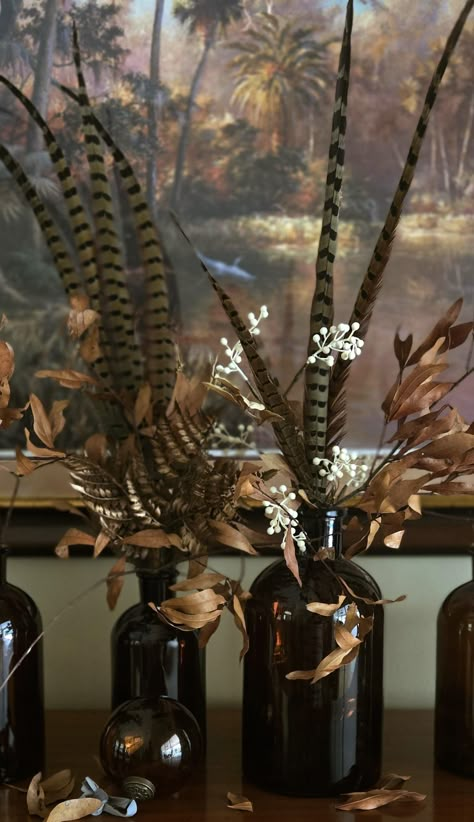 Amber glass and pheasant feathers Fall Pheasant Decor, Floral Arrangement With Pheasant Feathers, Turkey Feather Arrangement, Pheasant Feather Christmas Tree, Pheasant Feather Decor Wedding, Turkey Feather Centerpiece, Amber Glass Christmas Decor, Duck Wedding Decor, Pheasant Wedding Decor