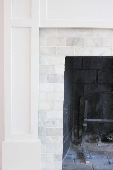 An outdated brick fireplace is resurfaced with marble tiles. Reface Brick Fireplace, Window Nooks, Mantle Makeover, Tile Styles, How To Tile, Brick Hearth, Diy Fireplace Makeover, Fireplace Bookshelves, Fireplace Update