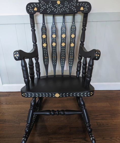 Large, solid wood, and super sturdy rocking chair. This is a repaint of my first rocking chair since I've decided to keep the last wooden one for now! The base color is a charcoal that appears more like dark blue in bright lighting. Lots of hand painted leaves, yellow flowers, and little gold details. 🌼 #handpaintedfurniture #handpaintedchair #handpaintedrockingchair #vintagerockingchair #rockingchair #accentchair #nurserydecor #nurserychair #fusionmineralpaint #colorfulhome #interiordesign ... Painted Chairs Ideas, Christmas Chairs, Blue Rocking Chair, Rocking Chair Makeover, Painted Rocking Chairs, Scandi Furniture, Hand Painted Chairs, Vintage Rocking Chair, Mural Inspiration