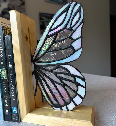 Finishing up my butterfly bookends this weekend. 🦋 I’m so happy with how these have turned out. Monarch on Oak and Glass wing on Pine. Bookend wood work by my dad 🥰 glass by me. A few more finishing touches and these will be ready to go. 🦋💕 Stained Glass And Wood Projects, Stained Glass Bookends, Stained Glass Butterfly Bookends, Butterfly Bookends, Stained Glass Butterfly Suncatcher, Stained Glass Butterfly Panel, Uni Dorm, Sun Catcher Butterfly Wings, Lead Light