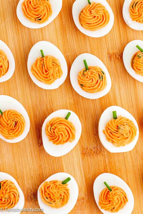 These deviled eggs are made to look like pumpkins and are so fun for Thanksgiving and Halloween! #pumpkin #deviled #eggs #halloween #thanksgiving Smokey Pumpkin Deviled Eggs, Fall Themed Deviled Eggs, Deviled Egg Pumpkins, Devil Deviled Eggs, Devilled Eggs Halloween, Roasted Red Pepper Deviled Eggs, Deviled Eggs Recipe Best Halloween, Pumpkin Deviled Eggs Recipe, Deviled Eggs Decoration Ideas