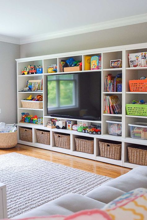 50+ Living Room Toy Storage Ideas That Keep Everyone Happy Playroom Desk And Storage, Kids Toy Room Storage, Kids Game Storage Ideas, Bonus Room Furniture Layout, Living Room Inspiration Kid Friendly, Megablocks Storage Ideas, Melissa And Doug Puzzle Storage, Lego Storage And Display, Legos Storage Ideas