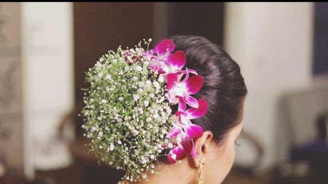 Intricate bridal hair bun with baby's breath and orchids Orchid Flower Hairstyle, Floral Hair Bun, Bridal Hair Bun, Reception Hairstyle, Reception Hairstyles, Flower Bun, Bridal Hair Buns, Hair Affair, Baby's Breath