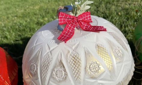 This post was transcribed by a member of the Hometalk editorial team from the original HometalkTV episode.Decorating your porch for the holidays couldn’t be easier with these easy-to-make giant ornaments. You can see more of my crazy creations here To make my giant ornaments, I grabbed 6 clear bowls from the Dollar Store. Large Plastic Christmas Ornaments, Diy Huge Ornaments, How To Make Large Ornament Balls, Dollar Tree Giant Ornaments Diy, Dollar Tree Jumbo Ornaments Diy, Dollar Tree Big Ornaments, Clear Bowl Decor Ideas, Ornaments From Dollar Tree Bowls, Dollar Tree Oversized Ornaments