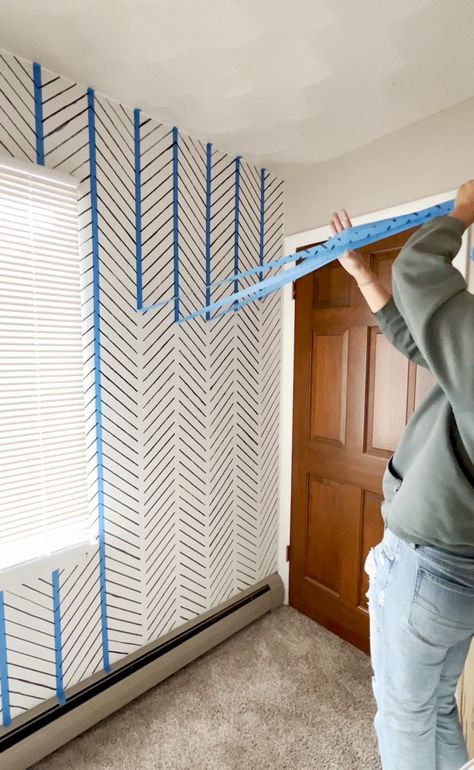 Transforming a room doesn't have to break the bank. In January 2023, my friend and I took on a fun DIY project to revamp our friend's nursery, and the results were nothing short of amazing....and it only cost $5!! With a simple yet effective technique, we were able to create a modern herringbone-style design that Boho Stencil Wall, Easy Wall Murals Painted Diy Boho, Geometric Wall Wood Diy, Chevron Painted Wall, Painted Lines On Walls Ideas, Sponge Accent Wall Diy, Sharpie Accent Wall, Diy Pattern Wall, Accent Wall Patterns