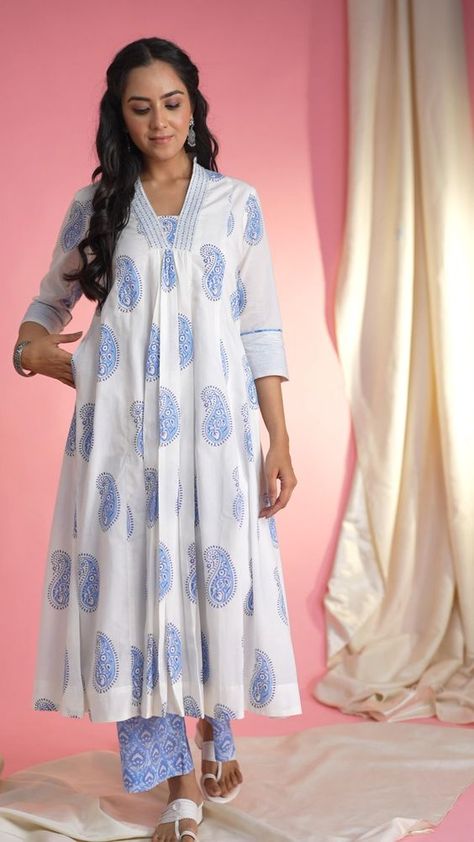 AVDAF281 Elevate your ethnic wardrobe with our exquisite Cotton Kurta Palazzo Set. Crafted from soft white fabric adorned with delicate booti patterns, the kurta features intricate handblock prints, a flattering A-line silhouette, and a V-neck highlighted with katha and bead work. The 3/4th sleeves with thread detailing and piping add an elegant touch, while the convenient pocket on one side offers functionality. Paired with light blue palazzos, boasting a comfortable back elastic. Cotton Dress Pattern, A Line Kurti, Kurta Palazzo Set, Stylish Kurtis Design, Kurta Patterns, Kurta Pant Set, Kurti Patterns, Designer Kurti Patterns, Simple Kurti Designs