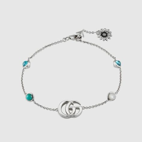 Shop the Double G flower bracelet by Gucci. The Double G—an archival reprisal of the House's signature emblem—appears on a bracelet, enriched with mother of pearl and topaz stones. The logo chain is attached with a small textured silver chain with a flower charm. Gucci Jewelry Bracelets, Turquoise Resin, Gucci Bracelet, Gucci Jewelry, Gucci Gg Marmont, Blue Topaz Stone, Gg Marmont, Flower Bracelet, Love Ring