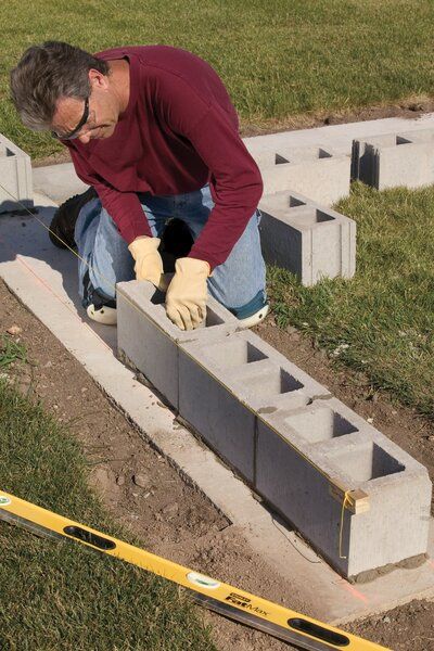 building-base-layer-of-concrete-wall-daf6884a Concrete Block Retaining Wall, Breeze Block Wall, Concrete Block Walls, Cinder Block Walls, Block Building, Cement Blocks, Cinder Blocks, Concrete Fence, Concrete Block